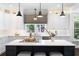 Bright kitchen with marble countertops, a central island with pendant lighting, and ample storage space at 5258 Tallgrass Nw Way, Kennesaw, GA 30152