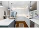 Well-lit kitchen featuring white cabinets, stainless steel appliances, and a central island with a cooktop at 5258 Tallgrass Nw Way, Kennesaw, GA 30152