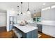 Open kitchen design featuring an island with seating, modern appliances, and white cabinetry at 5258 Tallgrass Nw Way, Kennesaw, GA 30152