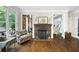 Bright living room showcasing hardwood floors, a stone fireplace, and a large window for natural light at 5258 Tallgrass Nw Way, Kennesaw, GA 30152
