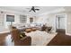 Spacious living room with a large sectional sofa, woven chairs, and decorative accents under a ceiling fan at 5258 Tallgrass Nw Way, Kennesaw, GA 30152