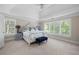 Spacious bedroom featuring tray ceilings, plantation shutters, and plush carpet at 5258 Tallgrass Nw Way, Kennesaw, GA 30152