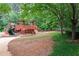 Community playground with play structure for residents with a bench and slide on a soft terrain at 5258 Tallgrass Nw Way, Kennesaw, GA 30152