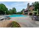 Stunning community pool with ample seating and a beautiful stone building for residents to enjoy at 5258 Tallgrass Nw Way, Kennesaw, GA 30152