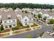 Community aerial view showcasing white modern farmhouse homes, green landscaping and gray shingles at 993 Harvest Park Ln, Suwanee, GA 30024