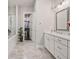 Elegant bathroom featuring a glass-enclosed shower, double vanity, and walk-in closet at 993 Harvest Park Ln, Suwanee, GA 30024