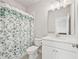 Bright bathroom features a white vanity, floral shower curtain, and a well-lit mirror at 993 Harvest Park Ln, Suwanee, GA 30024
