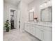 Elegant bathroom featuring a glass-enclosed shower, double vanity, and walk-in closet at 993 Harvest Park Ln, Suwanee, GA 30024