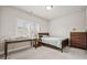 Cozy bedroom with a bed, desk, dresser, and natural light from the window at 993 Harvest Park Ln, Suwanee, GA 30024