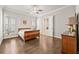 Comfortable bedroom with hardwood floors, plantation shutters, ensuite bathroom, and ample natural light at 993 Harvest Park Ln, Suwanee, GA 30024