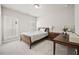 Inviting bedroom with a bed, desk, and ample natural light through shuttered windows at 993 Harvest Park Ln, Suwanee, GA 30024