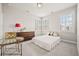 Comfortable bedroom with a cozy bed, dresser, and a round glass side table at 993 Harvest Park Ln, Suwanee, GA 30024