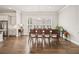 Bright dining room with large window featuring shutters, hardwood floors, and elegant lighting at 993 Harvest Park Ln, Suwanee, GA 30024