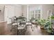 Bright dining room with a view, complemented by stylish furnishings and hardwood flooring at 993 Harvest Park Ln, Suwanee, GA 30024