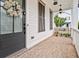 Charming front porch with a brick floor, decorative wreath, and white siding at 993 Harvest Park Ln, Suwanee, GA 30024