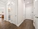 Hallway with dark wood floors, white walls, and multiple doors leading to other rooms at 993 Harvest Park Ln, Suwanee, GA 30024