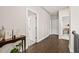 Hallway with beautiful wood flooring, multiple doorways, and stylish decorations on the side table at 993 Harvest Park Ln, Suwanee, GA 30024