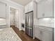 Bright kitchen featuring white cabinets, stainless steel appliances, granite countertops, and hardwood floors at 993 Harvest Park Ln, Suwanee, GA 30024
