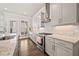 Bright kitchen featuring white cabinets, stainless steel appliances, granite countertops, and hardwood floors at 993 Harvest Park Ln, Suwanee, GA 30024
