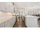 Bright kitchen featuring white cabinets, stainless steel appliances, granite countertops, and hardwood floors at 993 Harvest Park Ln, Suwanee, GA 30024