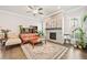 Comfortable living room showcases hardwood floors, fireplace, neutral colors, and ample natural light at 993 Harvest Park Ln, Suwanee, GA 30024