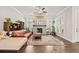 Cozy living room with brick fireplace, ceiling fan, and built-in shelves filled with plants at 993 Harvest Park Ln, Suwanee, GA 30024