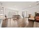 Bright and airy open-concept living and dining area features beautiful hardwood floors and shutters at 993 Harvest Park Ln, Suwanee, GA 30024