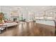 Spacious open-concept living area with a cozy fireplace, hardwood floors, and a modern kitchen at 993 Harvest Park Ln, Suwanee, GA 30024