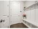 Bright mudroom featuring a built-in bench with storage, coat hooks, and a door to the exterior at 993 Harvest Park Ln, Suwanee, GA 30024