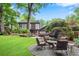 Landscaped backyard with patio seating area, lush lawn, and mature trees, offering a private outdoor oasis at 1291 Stillwood Ne Dr, Atlanta, GA 30306