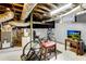 Unfinished basement space with exposed pipes and a bicycle setup, offering potential for customization at 1291 Stillwood Ne Dr, Atlanta, GA 30306