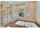 Spa-like bathroom with tiled walls, a glass-enclosed shower, and a separate soaking tub at 1291 Stillwood Ne Dr, Atlanta, GA 30306