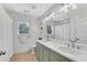 Bright bathroom featuring double sinks, a white countertop, and ample natural light from a window at 1291 Stillwood Ne Dr, Atlanta, GA 30306