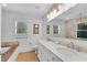 Bright bathroom with a marble countertop, dual sinks, and a soaking tub at 1291 Stillwood Ne Dr, Atlanta, GA 30306