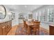 Bright dining room featuring hardwood floors, white trim, shutters, and decorative area rug at 1291 Stillwood Ne Dr, Atlanta, GA 30306
