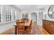 Bright dining room featuring hardwood floors, white trim, shutters, and decorative area rug at 1291 Stillwood Ne Dr, Atlanta, GA 30306