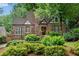 Charming brick home with Tudor accents, landscaped yard, and lush greenery at 1291 Stillwood Ne Dr, Atlanta, GA 30306