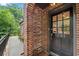 Brick exterior with a black front door, featuring sidelights and the house number at 1291 Stillwood Ne Dr, Atlanta, GA 30306