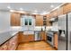 Kitchen featuring wood cabinets, stainless appliances, white subway tile, and hardwood floors at 1291 Stillwood Ne Dr, Atlanta, GA 30306