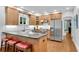 Kitchen featuring a kitchen island with seating, wood cabinets, and stainless appliances at 1291 Stillwood Ne Dr, Atlanta, GA 30306