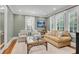 Inviting living room featuring a sofa, shuttered windows, and hardwood floors at 1291 Stillwood Ne Dr, Atlanta, GA 30306