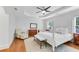 Airy main bedroom with hardwood floors features a white four poster bed and ample natural light at 1291 Stillwood Ne Dr, Atlanta, GA 30306