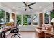 Bright, sunlit office with a desk, comfortable chair, and brick accent walls at 1291 Stillwood Ne Dr, Atlanta, GA 30306