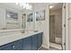 Stylish bathroom with blue vanity, modern fixtures, and a shower-tub combination at 2073 Woodside Park Dr, Woodstock, GA 30188
