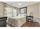 Relaxing bedroom features hardwood floors, ceiling fan, window, and soothing neutral decor at 2073 Woodside Park Dr, Woodstock, GA 30188