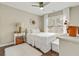 Cozy bedroom with white furnishings and ample natural light from the window at 2073 Woodside Park Dr, Woodstock, GA 30188
