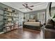 Comfortable bedroom featuring a daybed, dark wood floors, and bookshelf at 2073 Woodside Park Dr, Woodstock, GA 30188