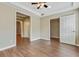 Bedroom featuring neutral walls, modern ceiling fan and two closets for plentiful storage at 2073 Woodside Park Dr, Woodstock, GA 30188