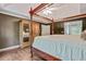 Main bedroom featuring hardwood floors, four poster bed, and plenty of natural light at 2073 Woodside Park Dr, Woodstock, GA 30188