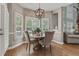 Bright dining area featuring hardwood floors and plantation shutters at 2073 Woodside Park Dr, Woodstock, GA 30188
